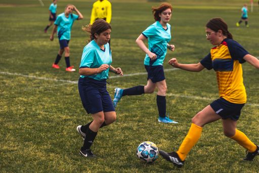 The young girls playing soccer at Youth Soccer Game