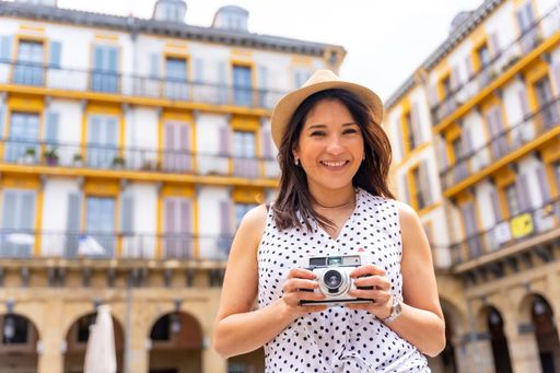 A Hispanic Tourist woman enjoying visiting the city looking at camera, enjoying summer vacation