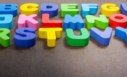 A closeup of colorful letters on the table under the lights - perfect for educational concepts