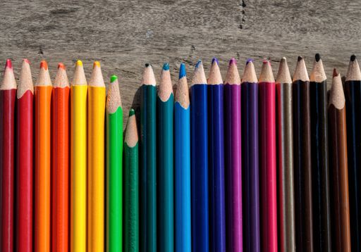 A closeup shot of colorful pencils in a shade sequence from the brightest to the darkest