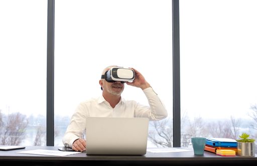 A male in a VR headset enjoying virtual project presentation at the office