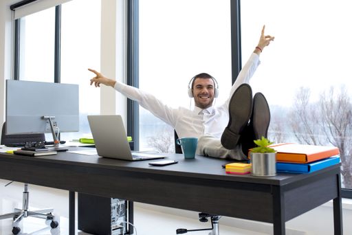 A male with headphones listening to music happily  during the break