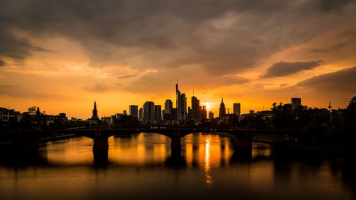 A beautiful summer view of Frankfurt skyline at golden sunset.Ignatz Bubis bridge on the river Main.Germany