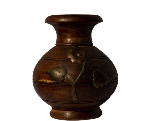 An isolated shot of a wooden vase with intricate design on a white background