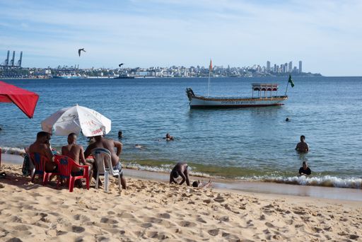 A closeup of people on Boa Viagem beach enjoying the strong sun in Salvador, Bahia, Brazil