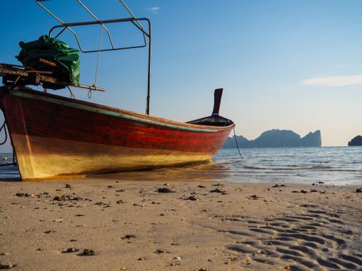 A fishing boat on a sandy beach on Phi Phi Islands, Thailand