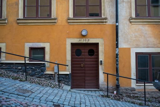 A beautiful shot of a number 10B building entrance on a slanted street