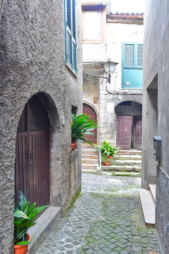 A narrow street with old houses in Guarcino, a village near Rome, Italy