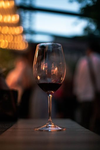 A selective focus shot of a glass of red wine