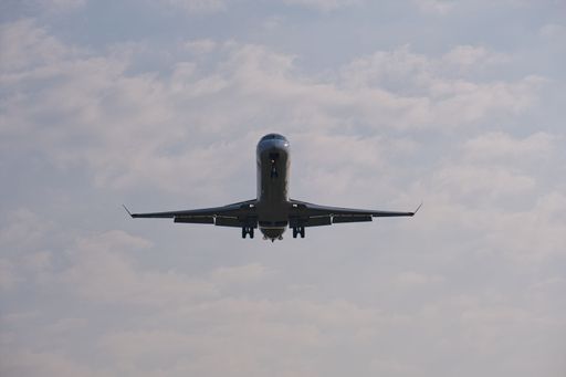 passenger plane on approach for landing, front view, from below