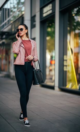 A vertical shot of a beautiful woman speaking on the phone