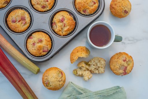 A top view of muffins with rhubarb and a cup of tea