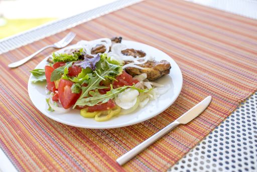 A closeup shot of a plate with meat and vegetables ready to be served