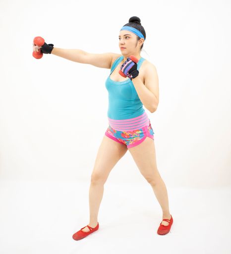 A beautiful athletic woman wearing sporty clothes and working out on a white background