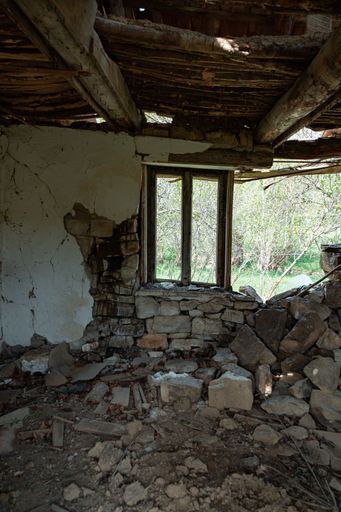 A vertical shot of an old damaged and abandoned building from the inside