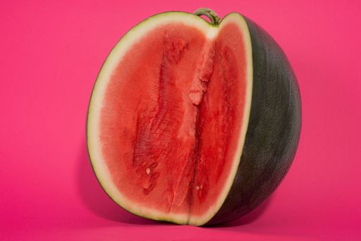 A closeup shot of a juicy watermelon on pink background