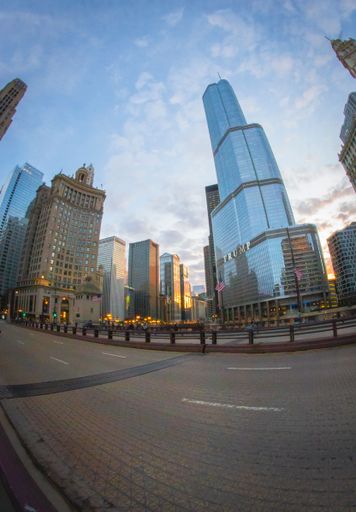 A cityscape with modern buildings and towers on a cloudy day