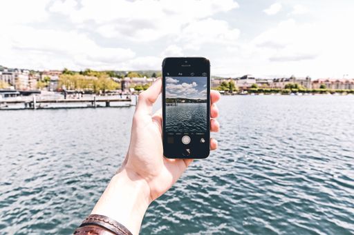 A person with a smartphone taking a photo of the beautiful surroundings - great for a cool background