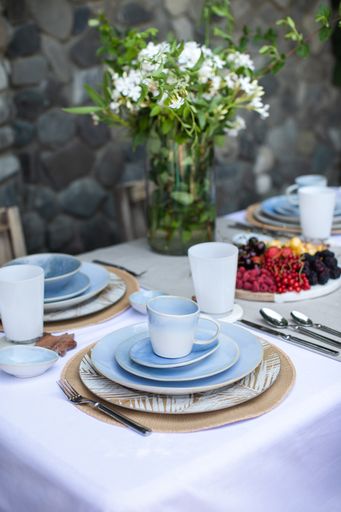 A closeup shot of blue ceramic tableware set on the table