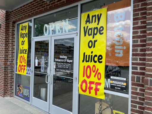 Augusta, Ga USA - 04 21 22: Sale signs at a Vape shop entrance