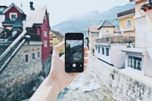 A person with a smartphone taking a photo of the beautiful surroundings - great for a cool background
