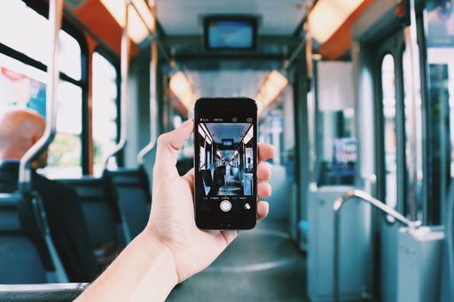 A person with a smartphone taking a picture of the inside of a bus - great for a cool background