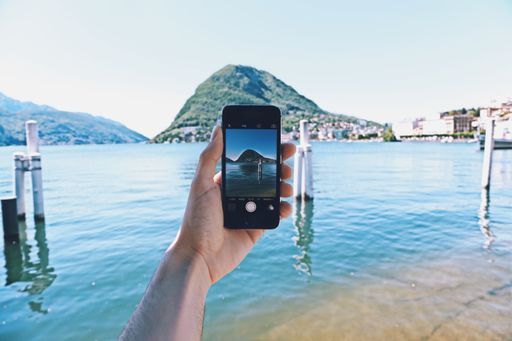 A person with a smartphone taking a photo of the beautiful surroundings - great for a cool background
