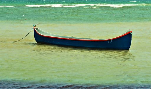 A small boat anchored in the turquoise sea