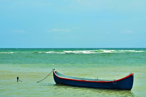 A small boat anchored in the turquoise sea