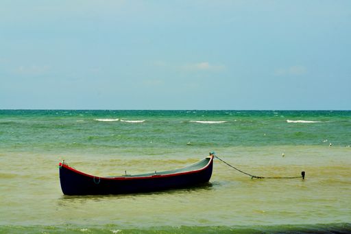 A small boat anchored in the turquoise sea