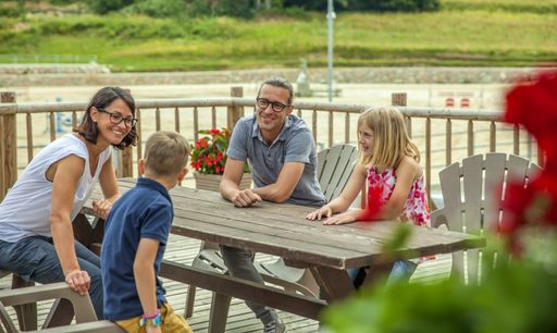 A happy family sitting next to a table and talking