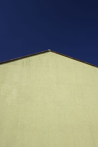 A low angle shot of stony wall of building in background of blue sky in Rhineland Palatinate