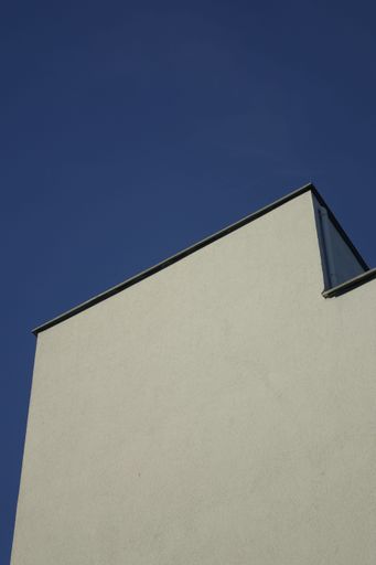 A low angle shot of stony wall of building in background of blue sky in Rhineland Palatinate