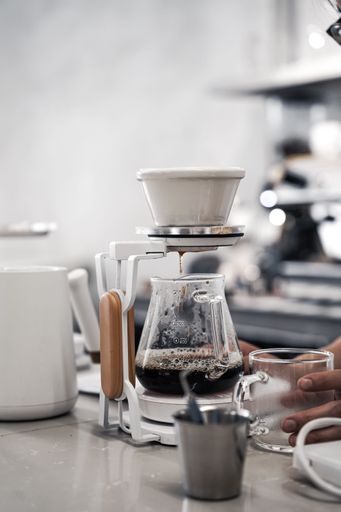 A vertical shot of gourmet filter coffee preparing at a cafe