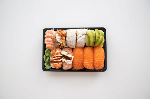 A top view of a plate of sushi on isolated white background