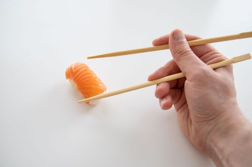 A closeup shot of a sushi sticks keep roll with fish and rice