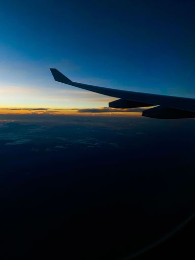 A vertical shot of the view from the airplane window during the sunset