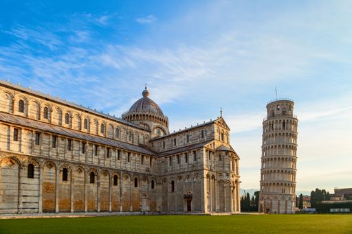 A scenic view of the Leaning Tower of Pisa and Pisa Cathedral in Italy on a sunny day