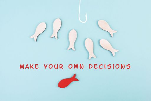 Group of fishes swimming to the fishing rod, red fish makes his own decision and takes a different direction, against the stream symbolic, courage a
