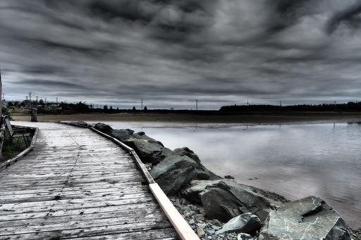 A dock on the lake and a dark cloudy sky over it in Halifax, Canada