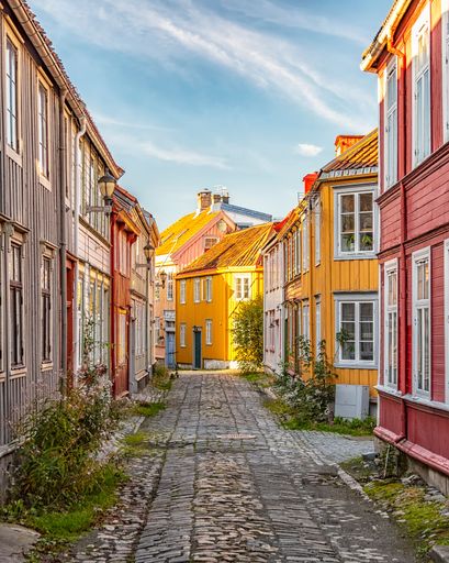 A vertical shot of colorful buildings on an old street in Trondheim, Norway