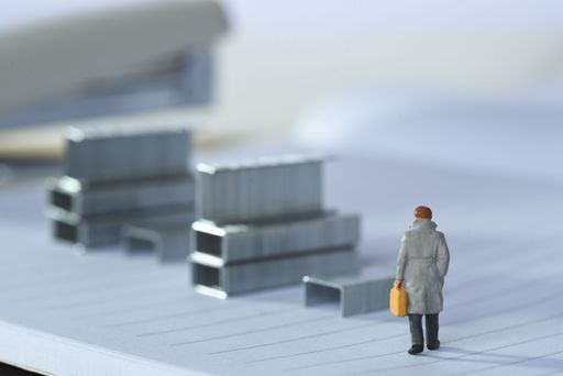 A human figurine walking alone in the empty station