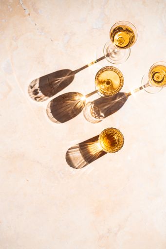 An overhead shot of wine glasses with shadow refection