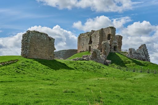 Spectacular view of ruins of Duffus Castle located in green valley on grassy hill near Elgin Moray, Scotland under blue cloudy sky