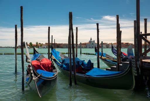 A beautiful shot of gondolas on the San Giorgio Maggiore background, Venice