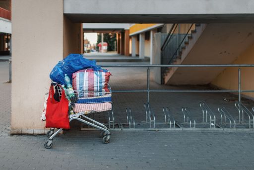 A stolen shopping cart used as a carrier for a Homeless man's possessions. The concept of poverty.
