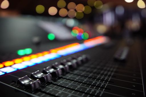 A closeup shot of DJ equipment with a bokeh background