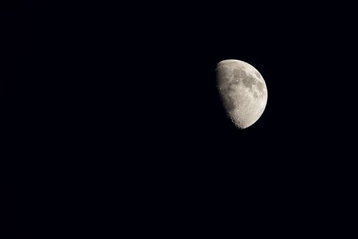 A scenic view of the quarter moon in the black space. Great for backgrounds