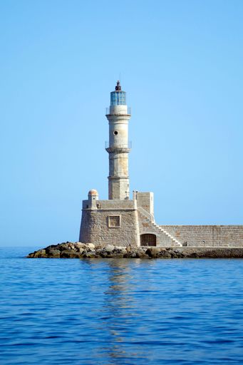 An old lighthouse guarding the entrance to the old Venetian harbour in Chania, Crete, Greece