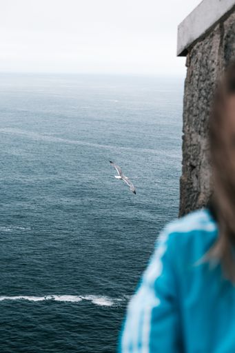 A vertical shot of a female enjoying sea view